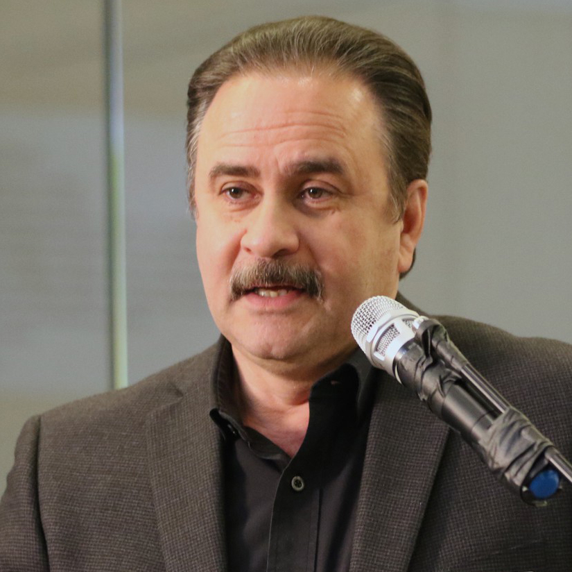headshot of hector cortez speaking at a podium
